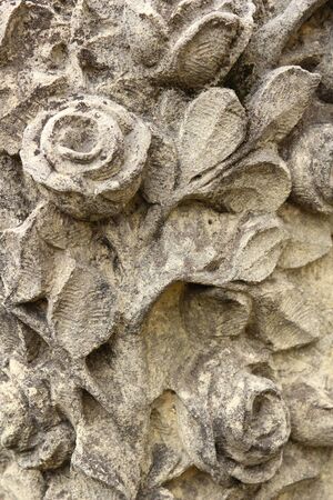 roses flowers and leaves carved in stone at a graveの写真素材