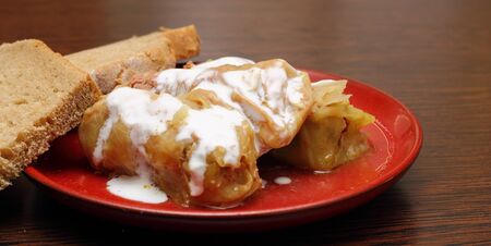 healthy eating - stuffed cabbage served with sour cream and black organic breadの写真素材
