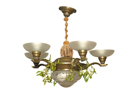 old beautiful chandelier with mistletoe on it over white backgroundの写真素材