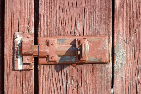 old metal locking system on a wooden doorの写真素材