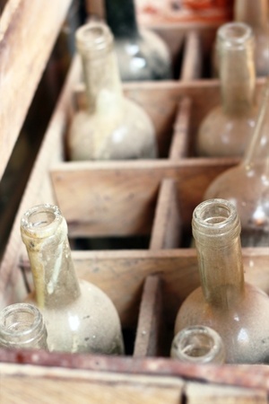 old empty wine bottles in a wooden boxの写真素材