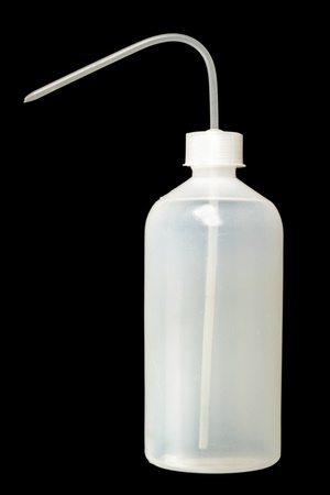 big plastic dropper isolated over dark backgroundの写真素材