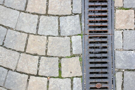 drainage on pedestrian street, textured background