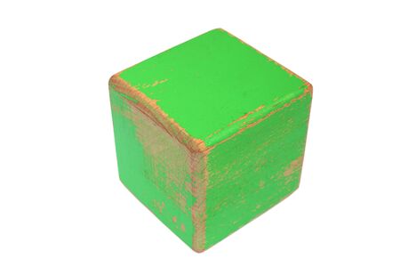 old wooden toy over white, weathered green painted cubeの写真素材