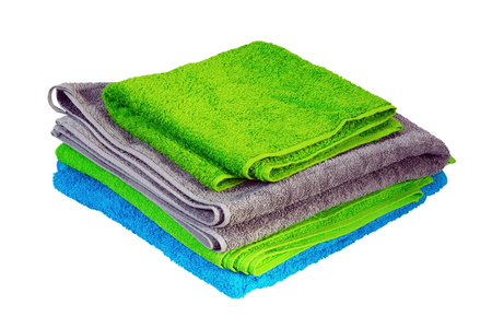 stack of colorful towels isolated over white background ( green, blue, gray )の写真素材