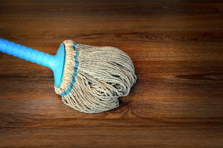 closeup of mop on the floor, cleaning interior wooden surfaceの写真素材