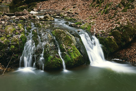 beautiful mountain stream over the rocks in Borzesti gorges, Romaniaの写真素材