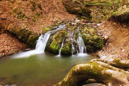 waterfall in early spring, long exposure image taken in Transylvania, Borzesti gorges, Apuseni mountainsの写真素材