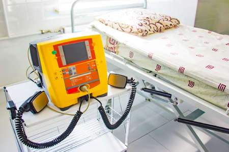 Background of new yellow defibrillator in hospital for health caring.の写真素材