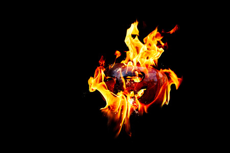 Halloween pumpkin is spewing fire flame flow on a black background is very impressive and colorfulの写真素材