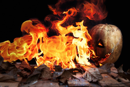Halloween pumpkin spewing flames of fire on a black backgroundの写真素材