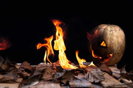 Halloween pumpkin spewing flames of fire on a black backgroundの写真素材