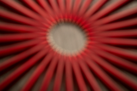 Blured A lot of red pens in a circle on a black wooden background. Concept office or school, knowledge day, the first of September. great pattern beckgroundの写真素材