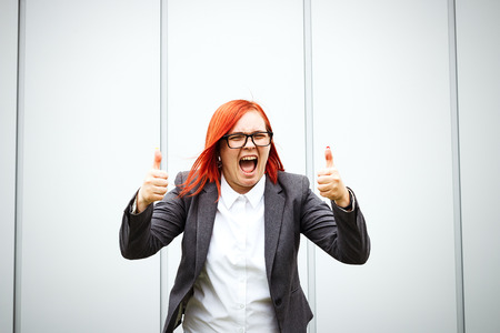 Business concept of success. Serious Successful Woman chef, in a suit and wearing glasses emotionally shows a gesture class like. With a place for advertising text. Chef Day, Boss Dayの写真素材