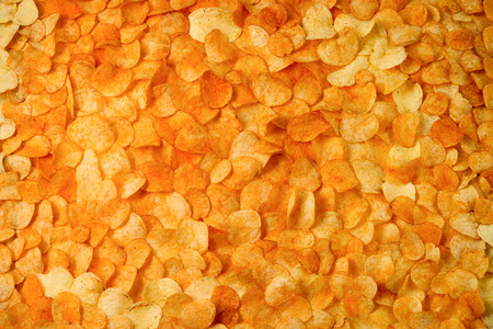 Golden Chips potato texture. Great Food Background of delicious chipsの写真素材