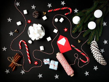 Christmas New Year composition fir branches pine cone cinnamon vintage gifts thread paper candy stick marshmallow letter stars Top View  vintage styleの写真素材