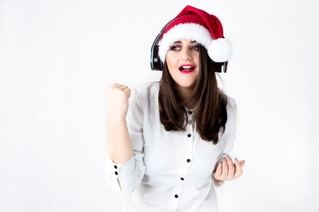 Spirit of Christmas thick girl in Santa Claus cap model XXL, woman plus size in lingerie fat Santa listen music with headphonesの写真素材