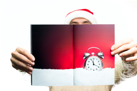 Christmas new year concept food and sweets. Man in santa claus hat holding journal. guy hold journal...