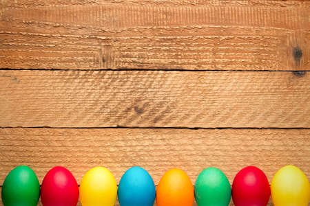 Easter concept painted eggs on wooden table for holiday with place for text pattern with frame