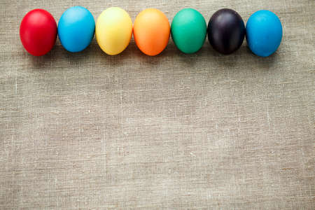 Easter concept painted eggs on cloth in row for holiday with place for text pattern with frame