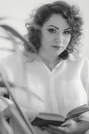 Plus size woman in shirt read book, monochrome photo with grain. vintage pictureの写真素材