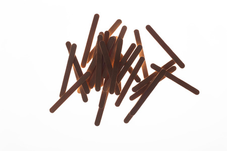 Many wooden ice cream sticks in heap on white background isolated, flat layの写真素材