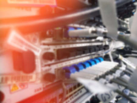 Blurred photo. Switchboard with many switches and fiber optic cables. Internet switchboard. Mobile...
