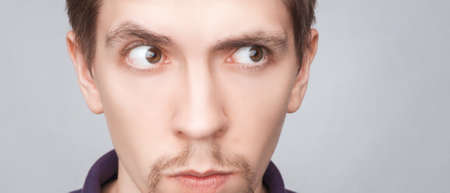 Emotions concept. Portrait of shocked surprised male with small beard, looks bugged eyes, being confused to see something unexpected. Close-up guy with surprised expression.の写真素材