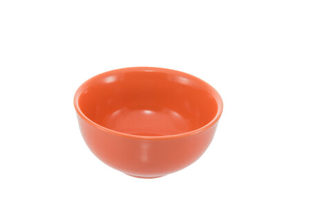 Orange ceramic bowl isolated on whiteの写真素材