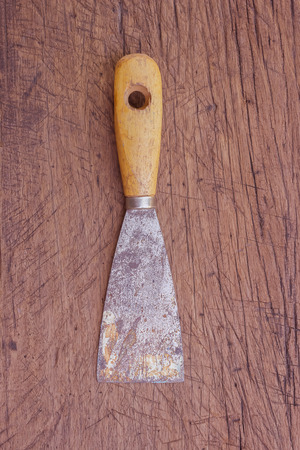 old rust paint trowel with wood handleの写真素材