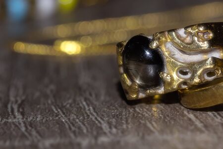 Closeup of gold ring on woodの写真素材