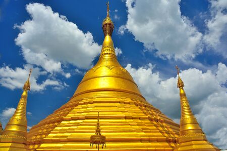 Golden pagoda of a buddha in Thailand.の写真素材