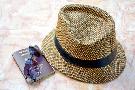 Accessories for travel. Passport and  Hat, sunglasses on stone table.の写真素材