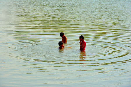 Children playing water in a weir,KANCHANABURI,THAILAND , 23 APRIL 2O17の写真素材