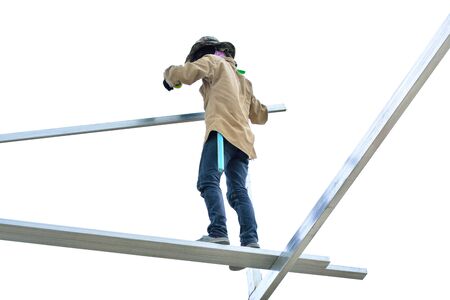 Construction workers working on roof frame used to reinforce concrete at white background.