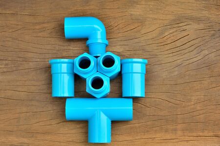 Plumbing fittings put together on brown wood table backgroundの写真素材