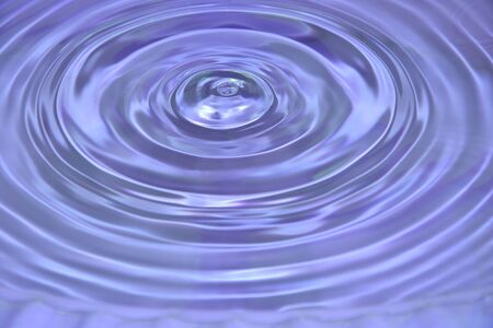 Abstract wave water drop on purple background.