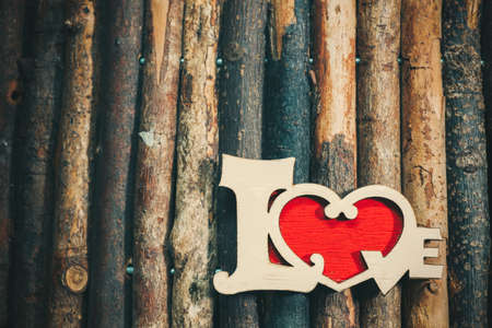 Vintage wooden love shape in wooden backgroundの写真素材