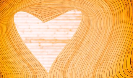 Yellow color heart shaped made by wooden curve.の写真素材