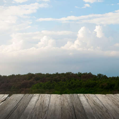 Blue sky with cloud, wooden board on foregroundの写真素材