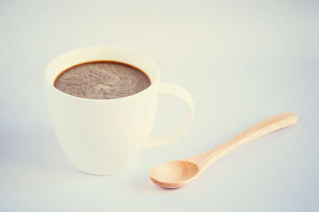 Coffee cup with wooden spoon on white backgroundの写真素材