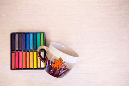 Christmas cup with color in box on wooden table with copy space.の写真素材