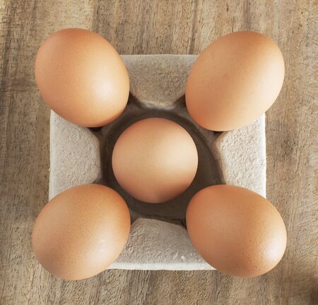 fresh brown eggs on table.