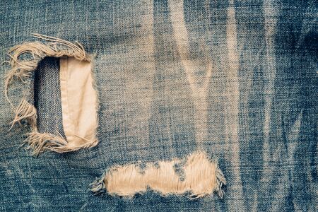 Closeup of a part of the jeans that is a bit torn