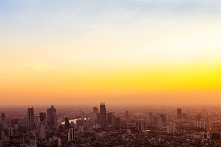 Aerial view to Bangkok downtown in the mist at sunrise,  Thailand.の写真素材