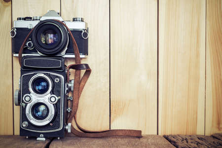 Retro film cameras on wood background with free copy space, vintage background.の写真素材