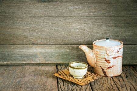 Still life of set of japanese ceramic teapot and cup on wooden texture background.の写真素材