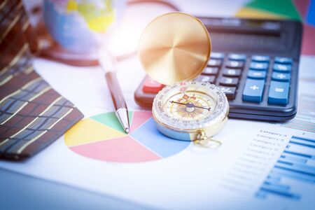 Business analyzing investment charts with laptop, calculator, pen, compass. Accounting. Vintage filtered.の写真素材