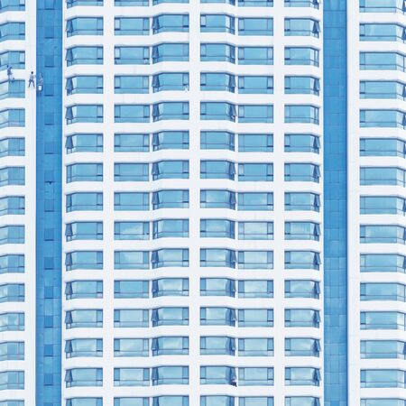 Close up of office building with reflection of blue sky. Business background.の写真素材