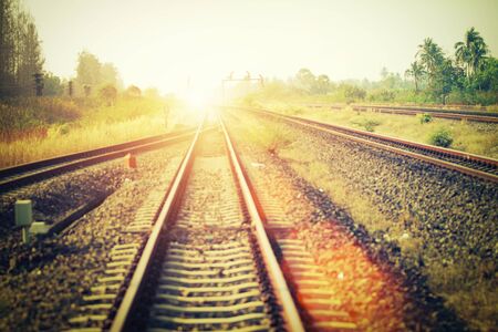 Soft focus of landscape of railroad tracks at train station in sunset. Vintage filtered.の写真素材